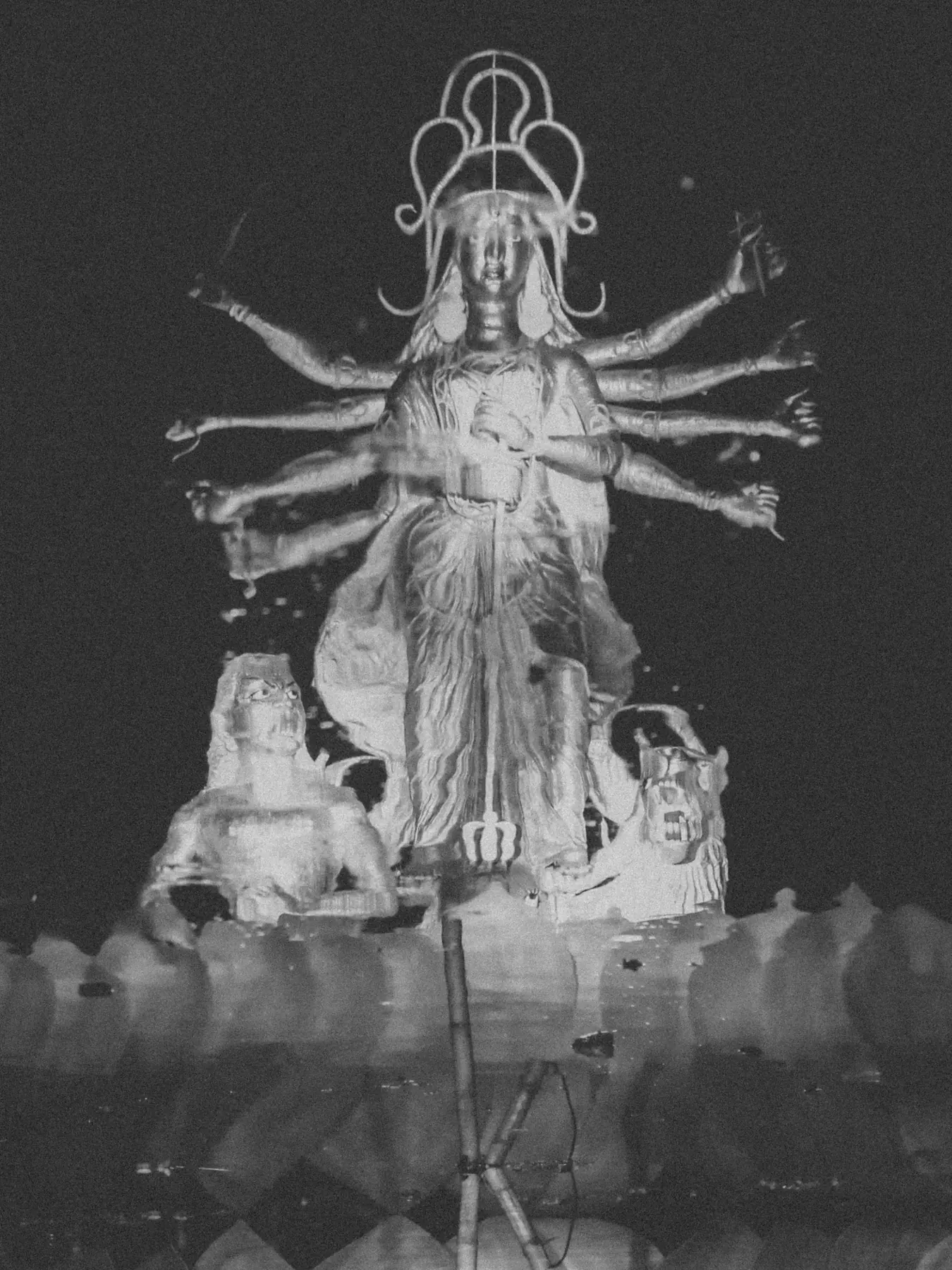 Black and white statue of a many-armed deity